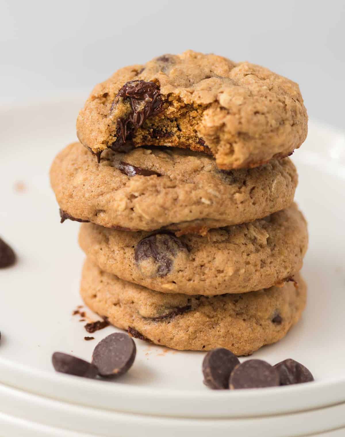 four cookies stacked with the top one taken a bite out of