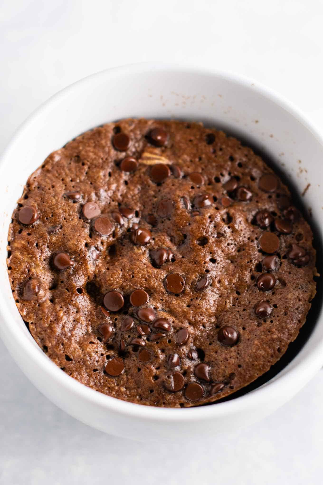 Gluten free chocolate mug cake made with easy to find flours. Perfectly fluffy and so decadent - serve with ice cream!