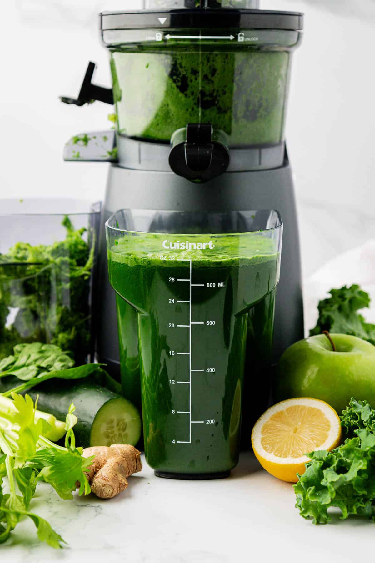 green juice next to a juicer