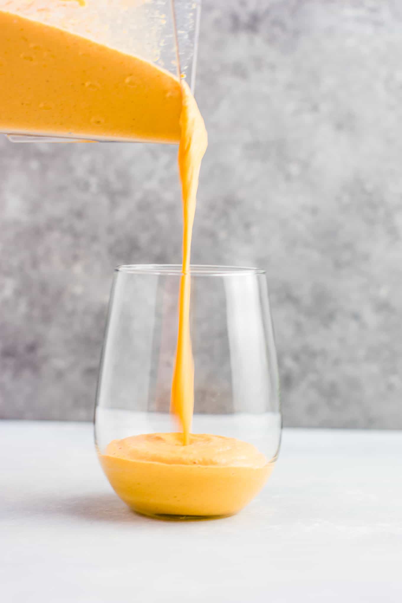 Frozen pumpkin pie smoothie poured into a glass