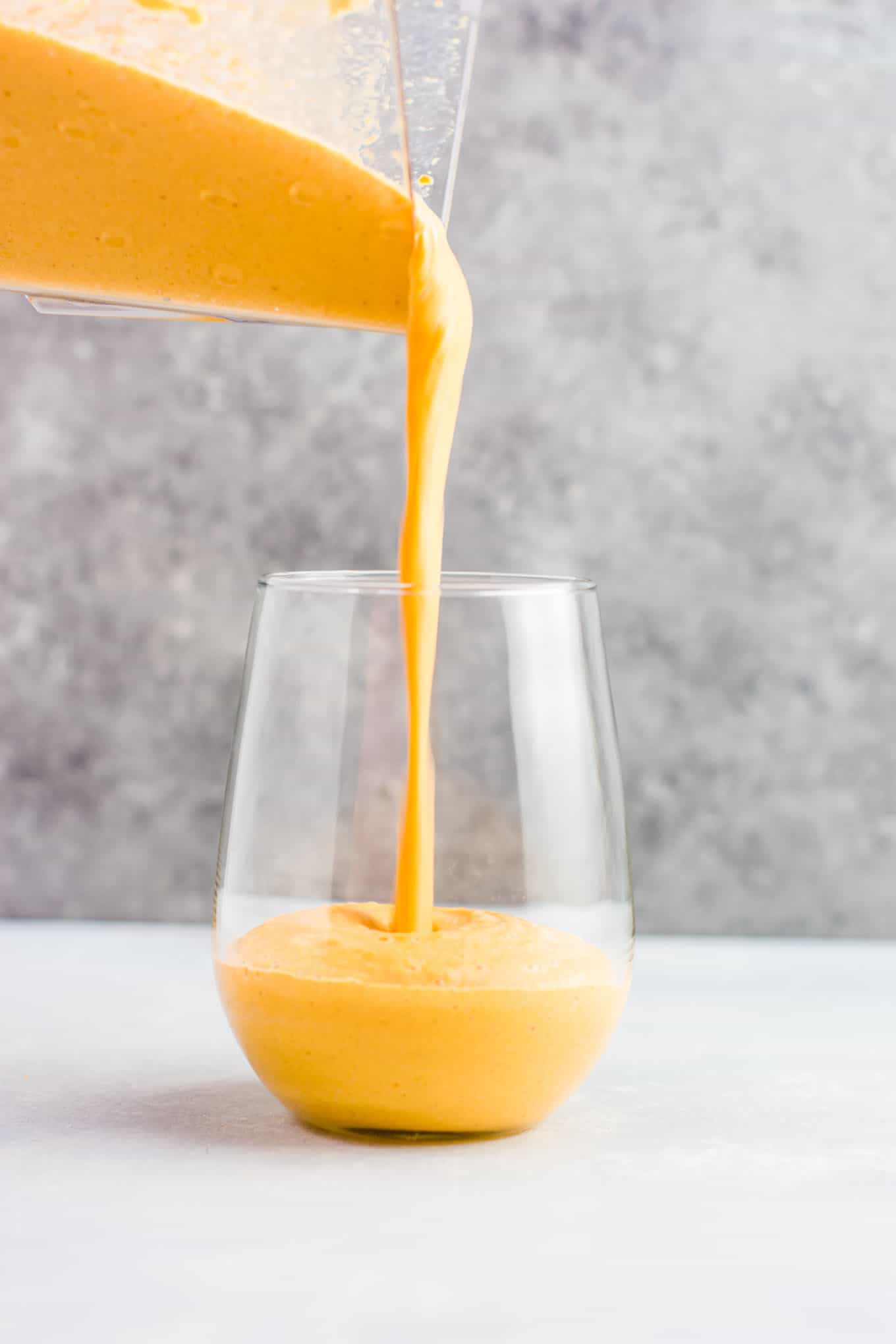 Frozen pumpkin pie smoothie poured into a glass