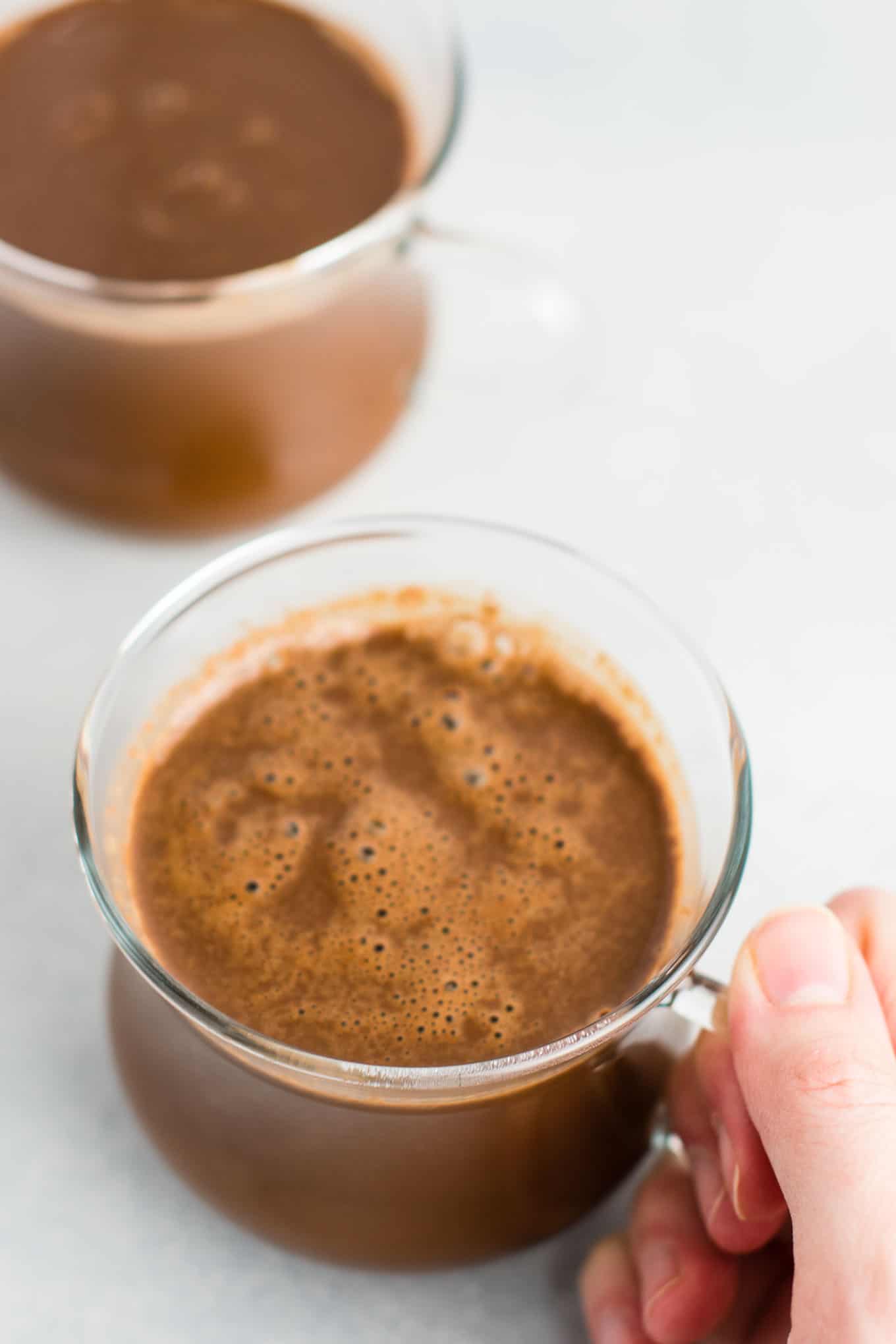 Easy 4 Ingredient vegan hot chocolate recipe made with almond milk. Dairy free, gluten free, and vegan. The perfect cozy winter drink! #vegan #hotchocolate #drinks #christmas #dairyfree