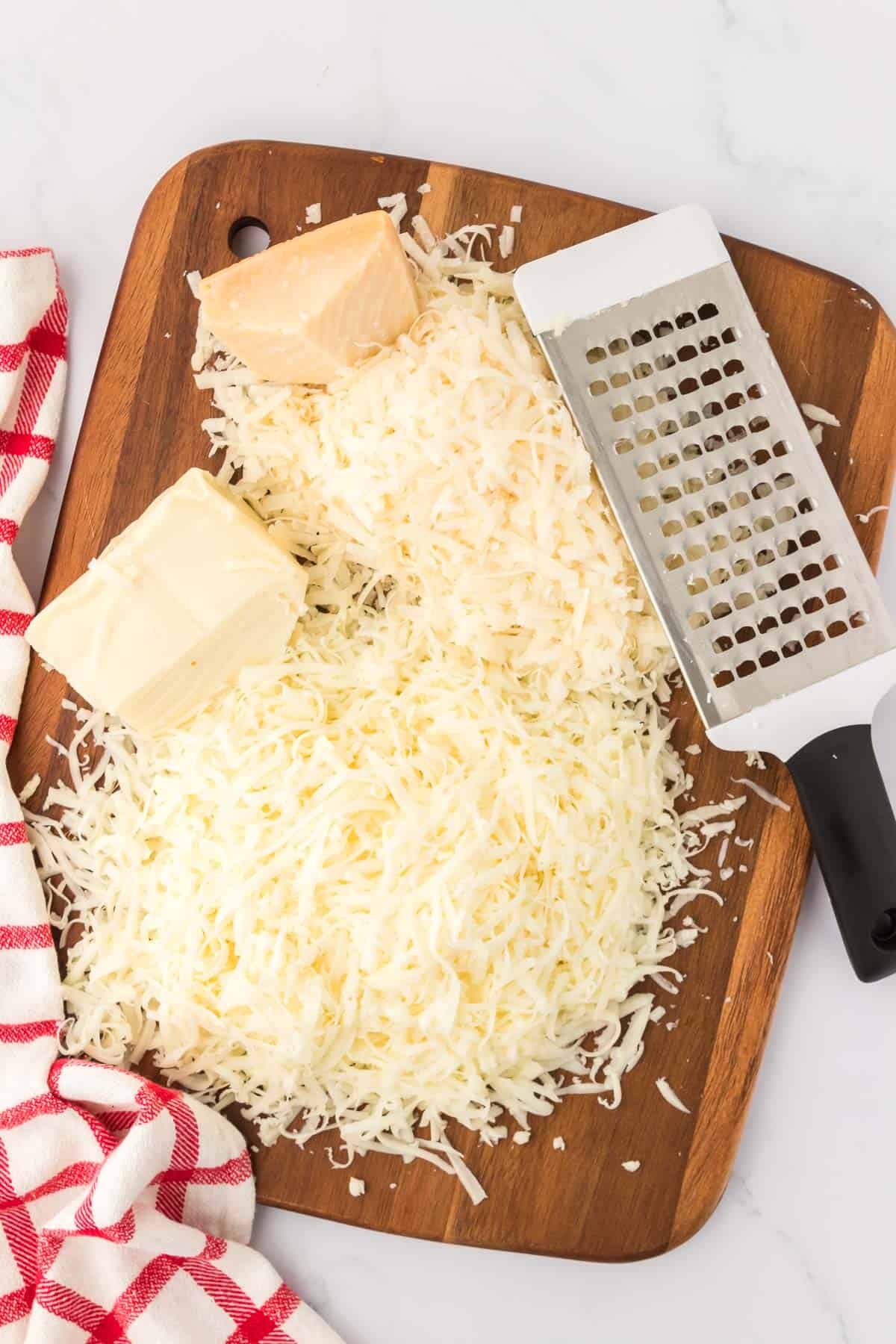 grated cheese on a cutting board