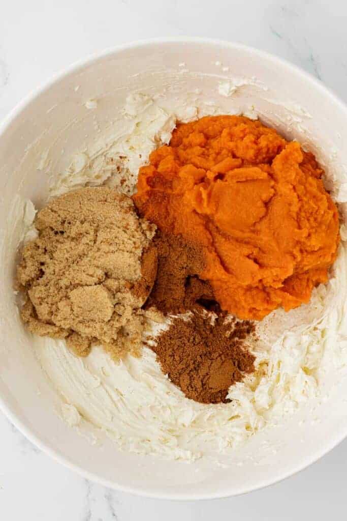 adding the pumpkin, spices, and brown sugar to the cream cheese