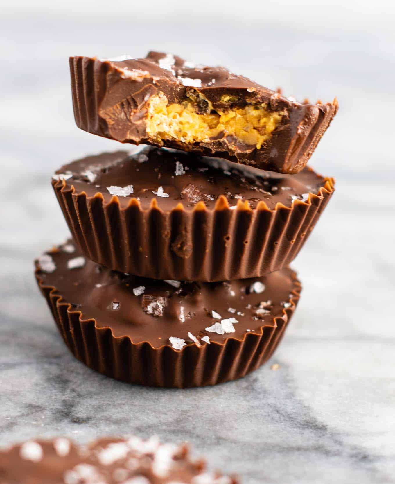 Chocolate peanut butter crunch cups with flaked sea salt – these are next level DELICIOUS! Vegan, gluten free, and tastes so good you won’t want to share! Perfect treat to keep in the freezer! #vegan #glutenfree #dessert #reesescups #vegandessert #glutenfreedessert #christmas #holidaytreat #seasalt