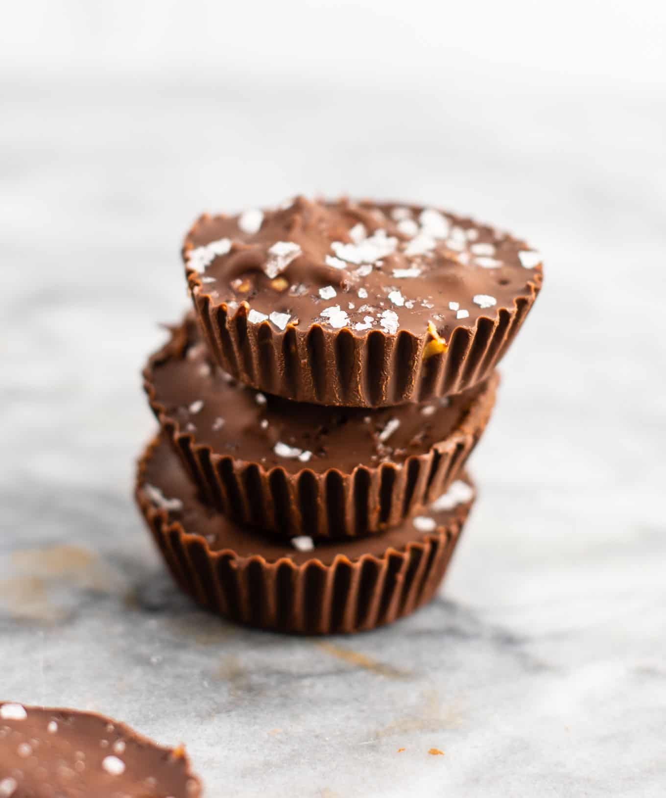 Chocolate peanut butter crunch cups with flaked sea salt – these are next level DELICIOUS! Vegan, gluten free, and tastes so good you won’t want to share! Perfect treat to keep in the freezer! #vegan #glutenfree #dessert #reesescups #vegandessert #glutenfreedessert #christmas #holidaytreat #seasalt