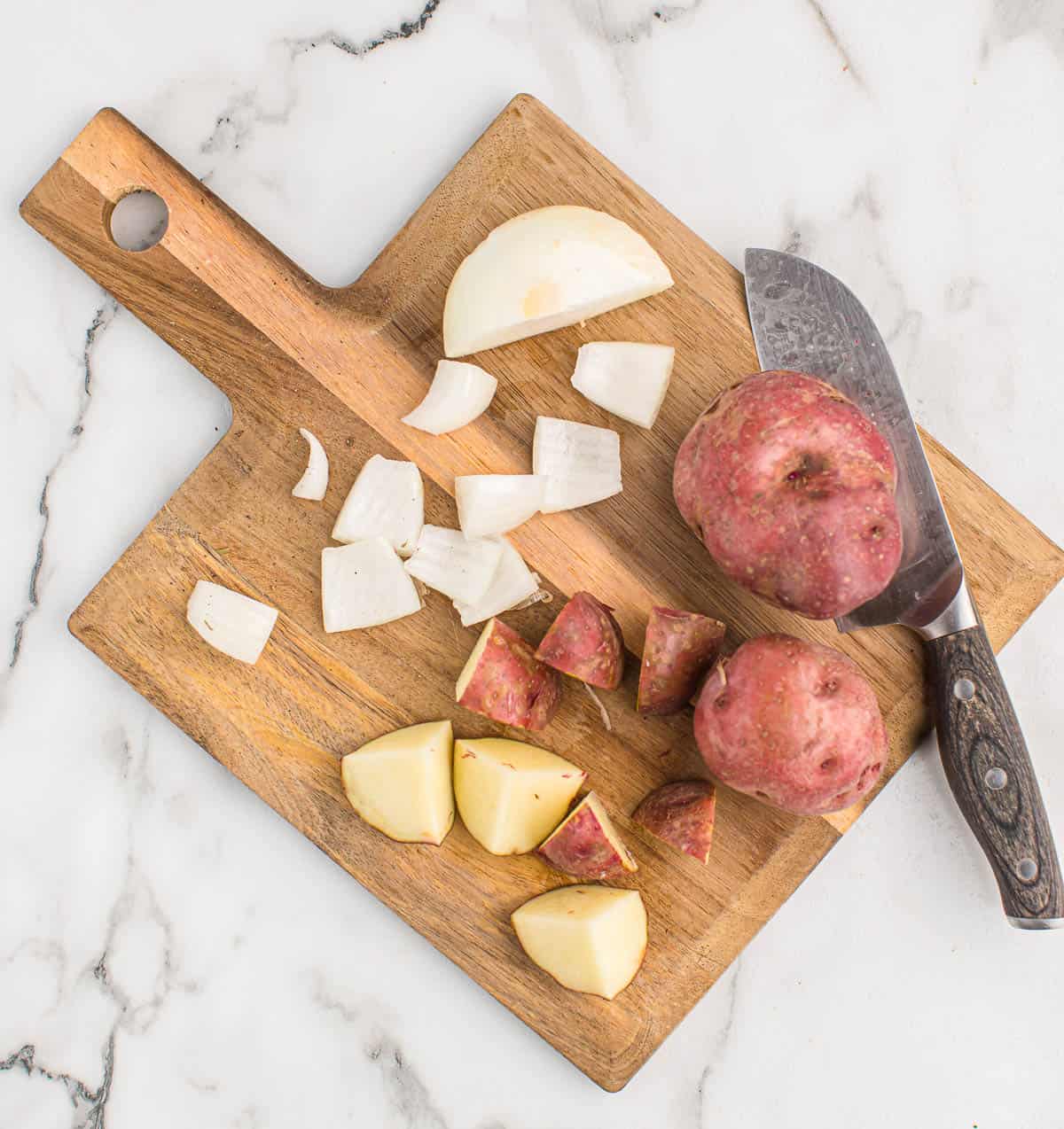 cutting up red potatoes and onions