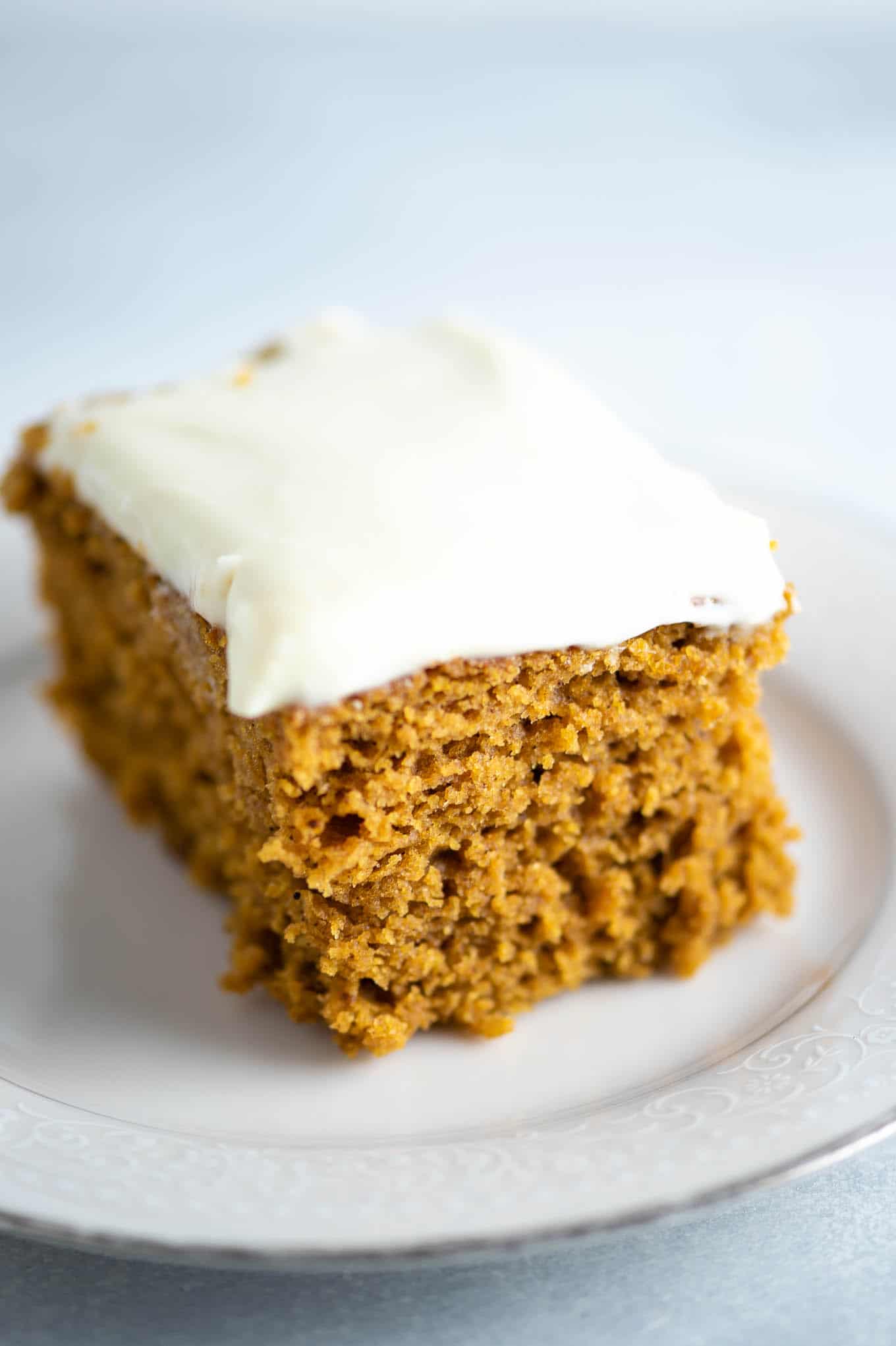 pumpkin cake slice with cream cheese frosting