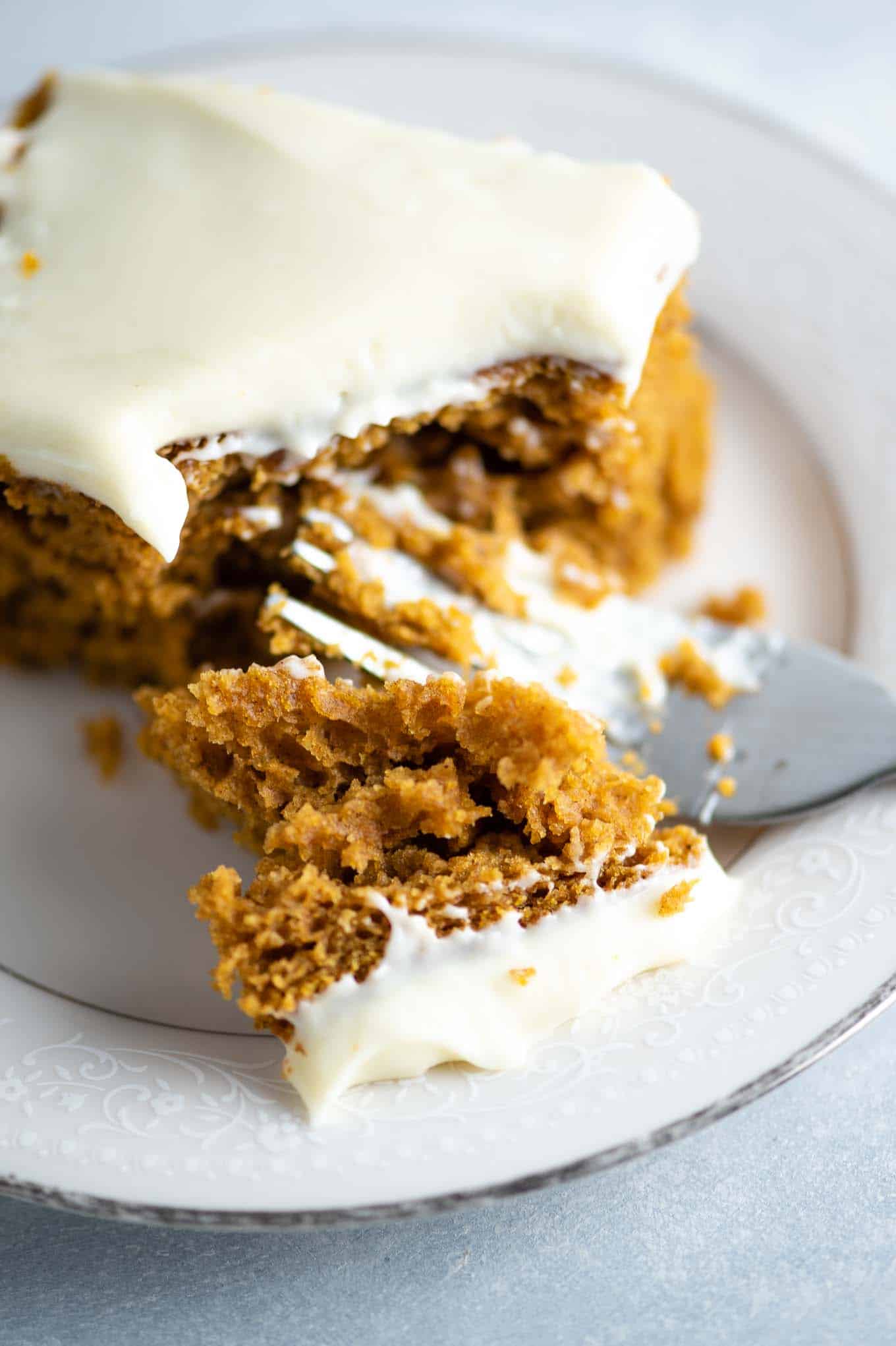 up close image of a bite of cake with frosting on it