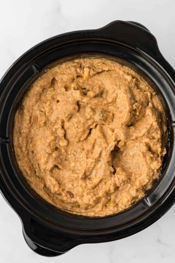 bean dip in a black slow cooker