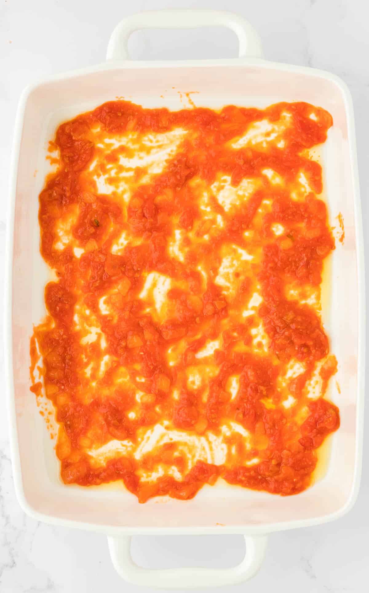 sauce spread out in a baking dish
