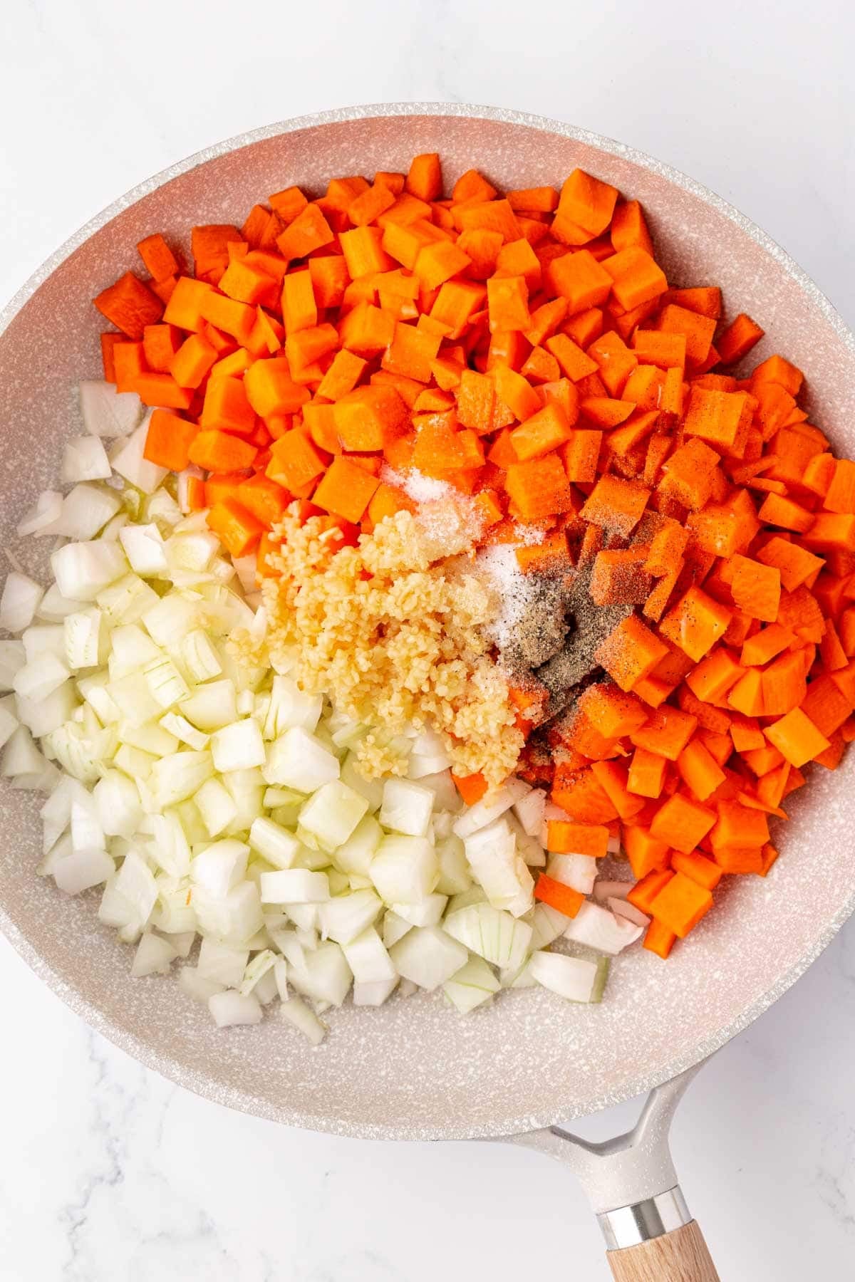carrots, onions, garlic, and spices in a skillet
