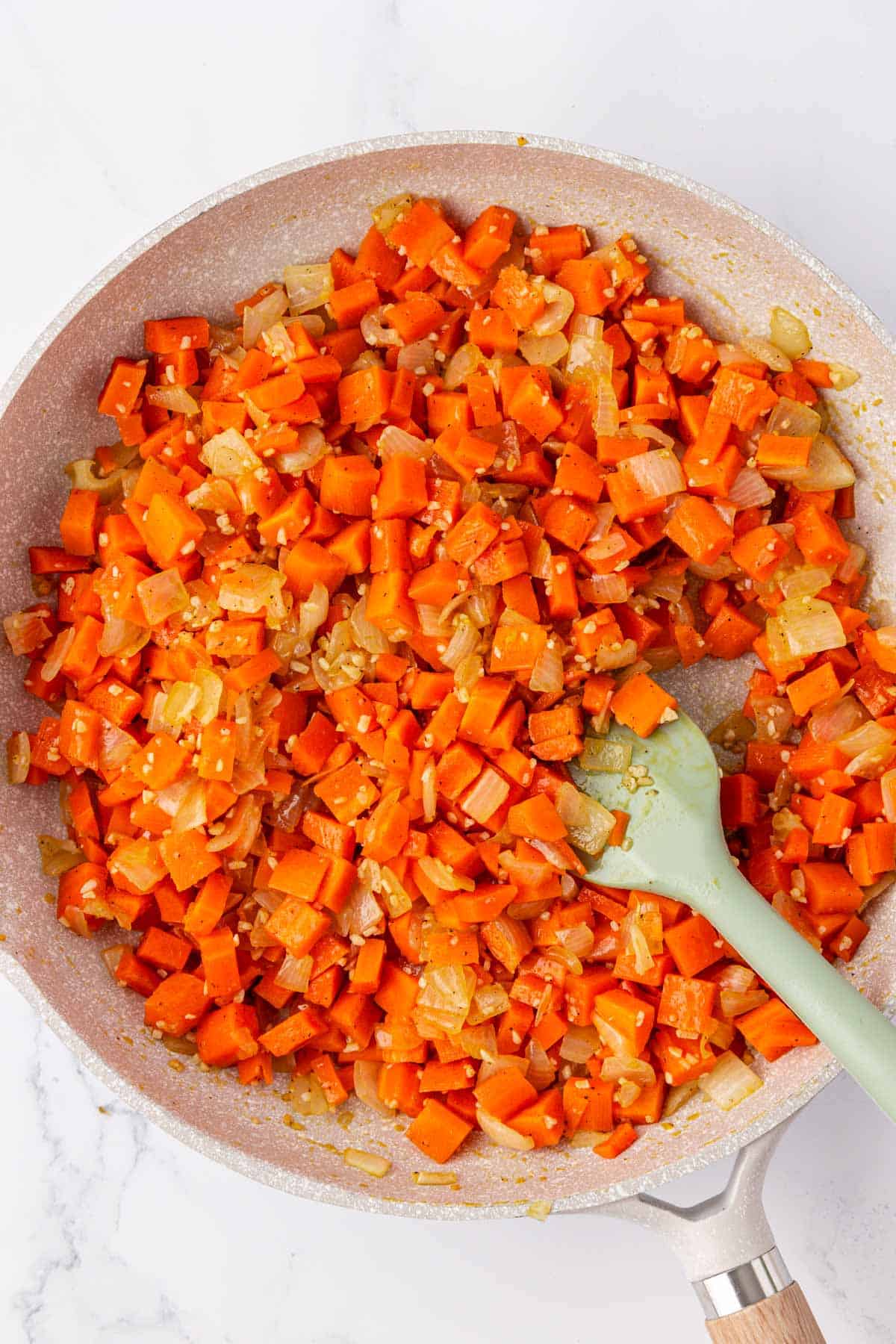 cooked carrots with onions in a skillet