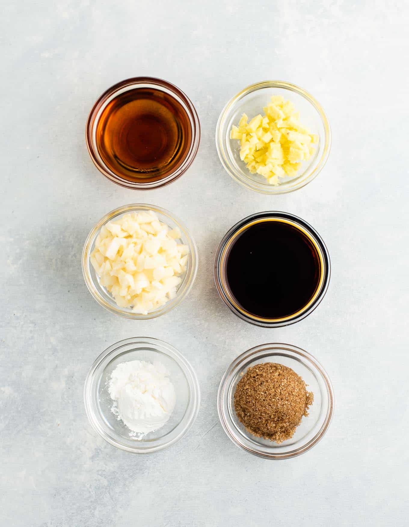 6 small bowls with sesame oil, ginger, garlic, soy sauce, cornstarch, and brown sugar