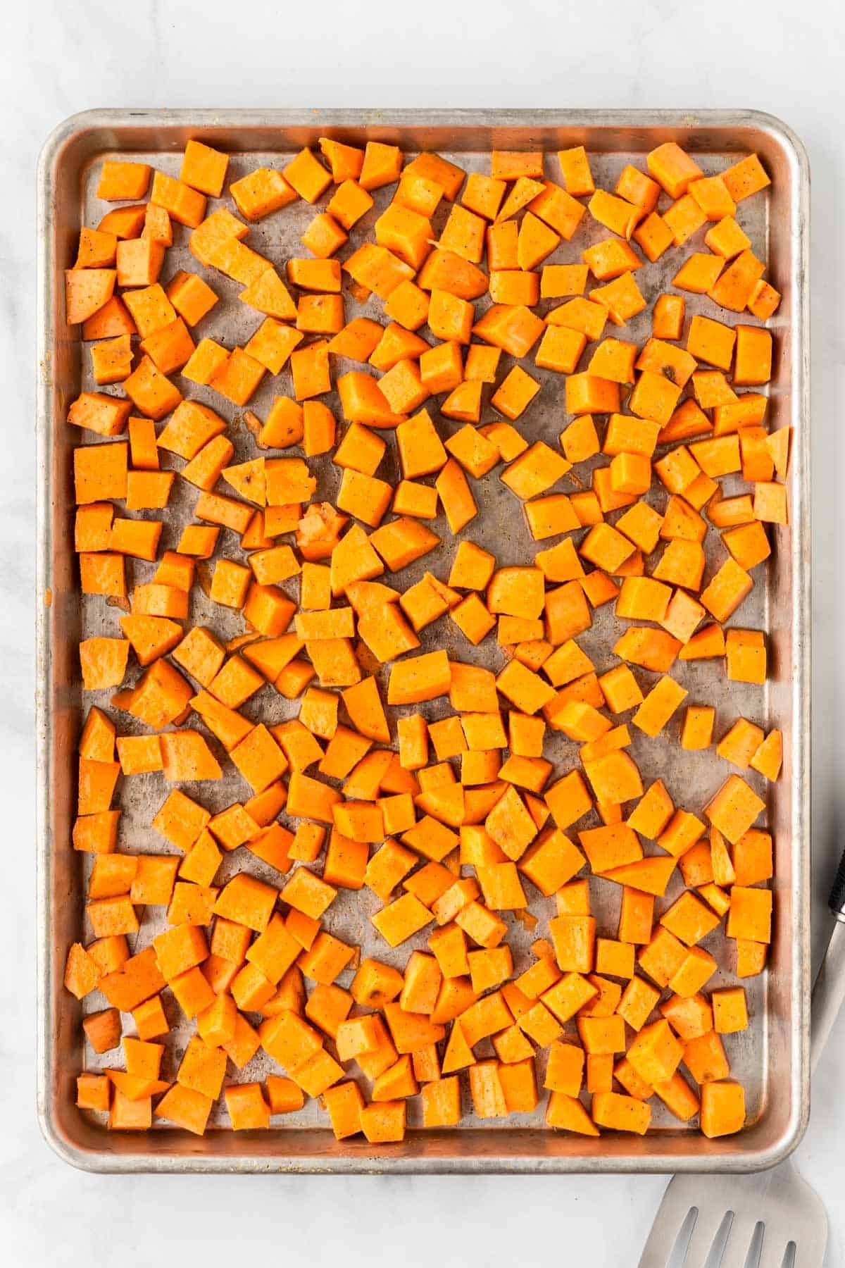 sweet potato cubes on a baking sheet