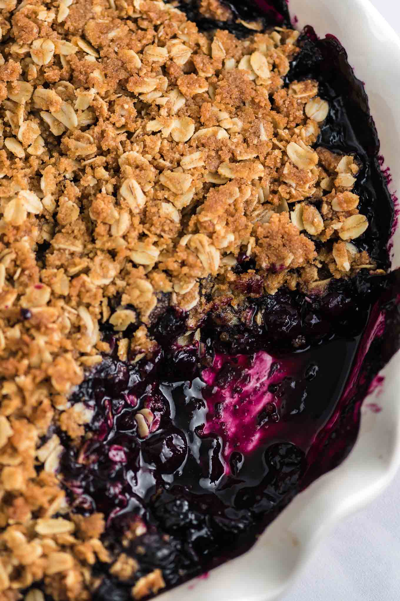 blueberry crisp dish with a spoonful taken out