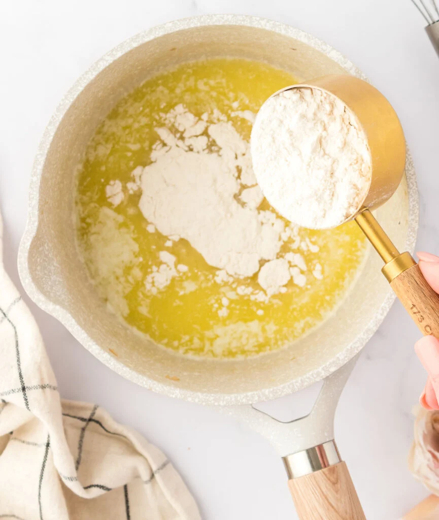 adding flour to melted butter