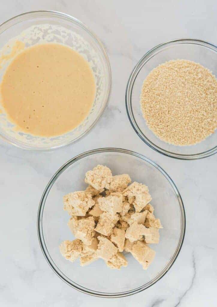 torn tofu, batter, and panko bread crumbs in separate bowls