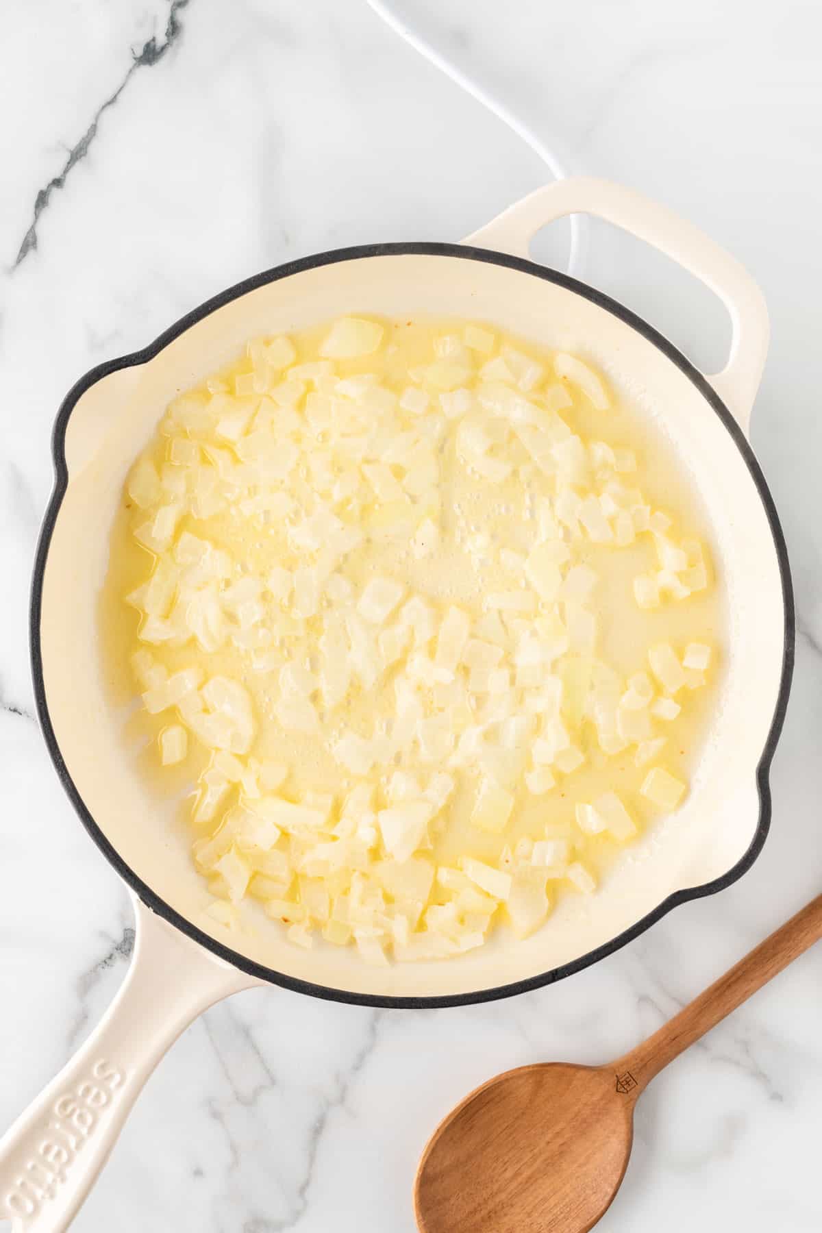 adding garlic and onion to the skillet
