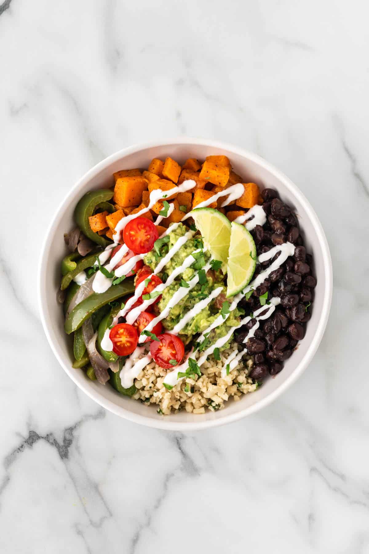 drizzling the burrito bowl with sour cream
