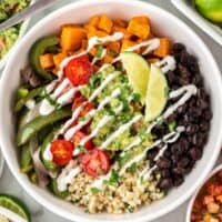 cauliflower rice burrito bowl with black beans, fajita veggies, sweet potatoes, and guacamole