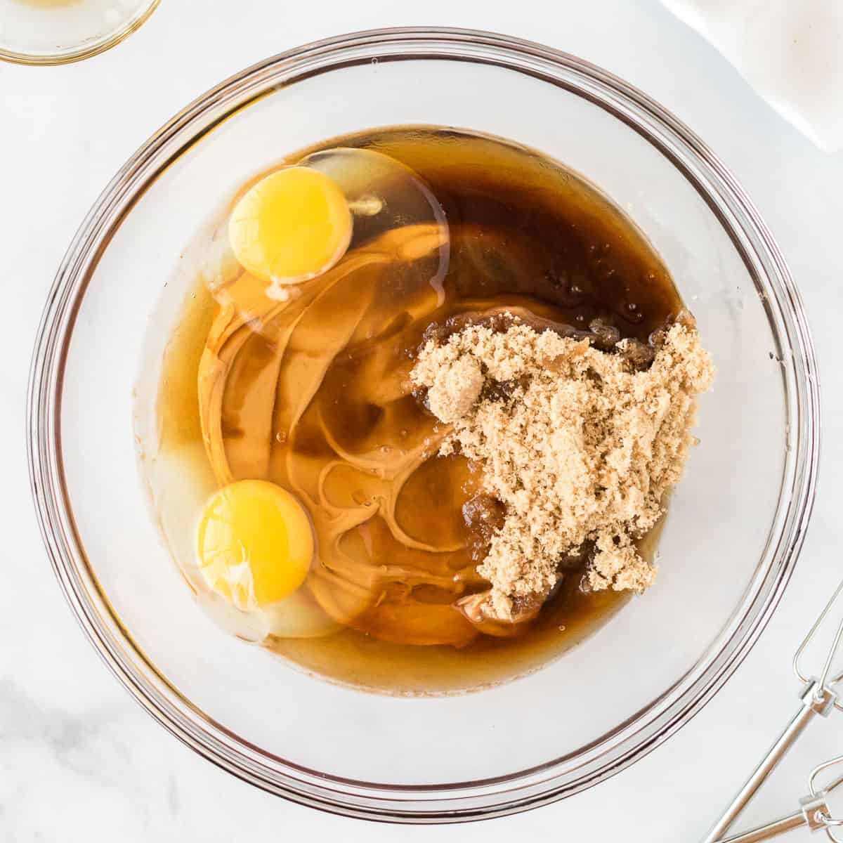 brown sugar, eggs, and maple syrup added to the peanut butter