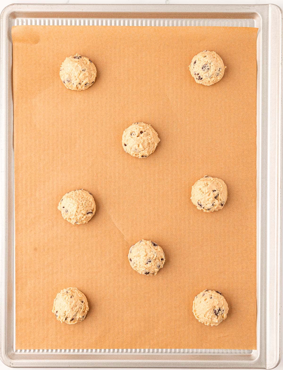 vegan chocolate chip cookie batter on a baking sheet