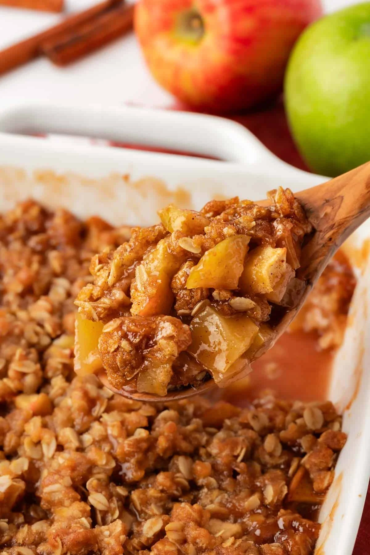 wooden spoon scooping vegan apple crisp