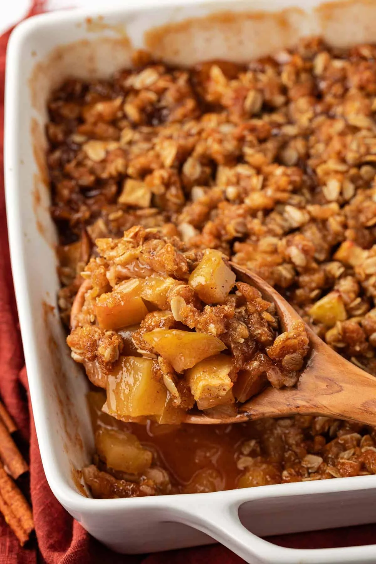 wooden spoon scooping vegan apple crisp