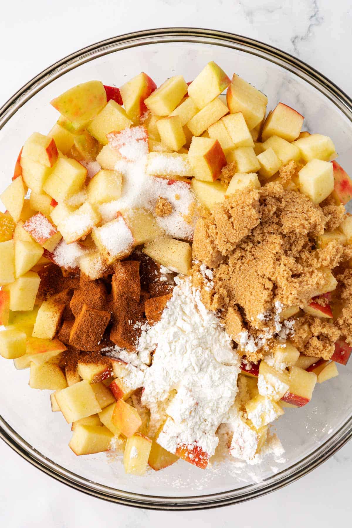 adding the spices to the apples