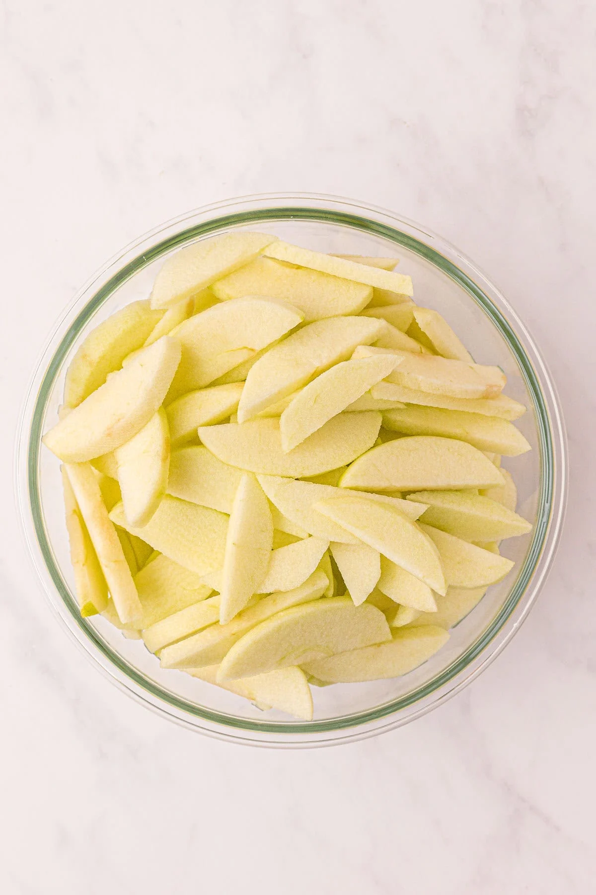 sliced apples in a mixing bowl