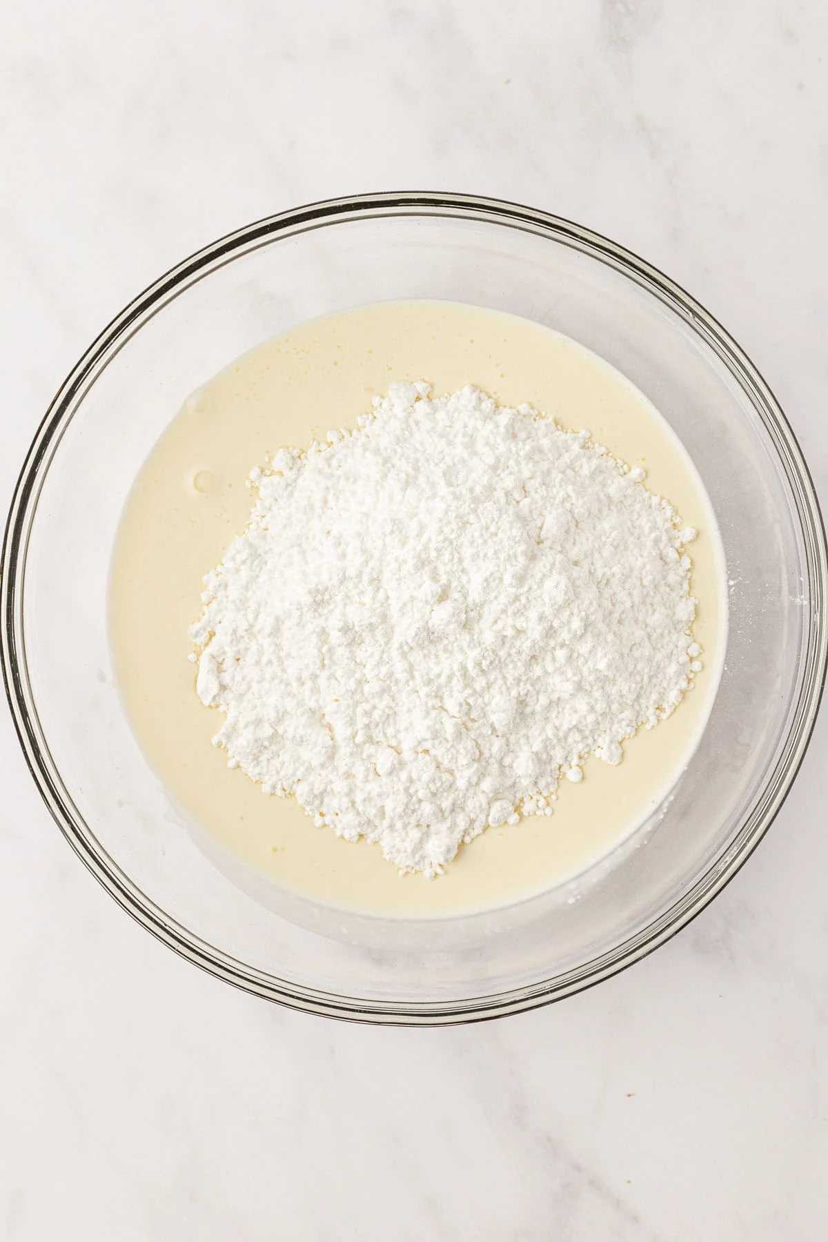 heavy cream and powdered sugar in a mixing bowl