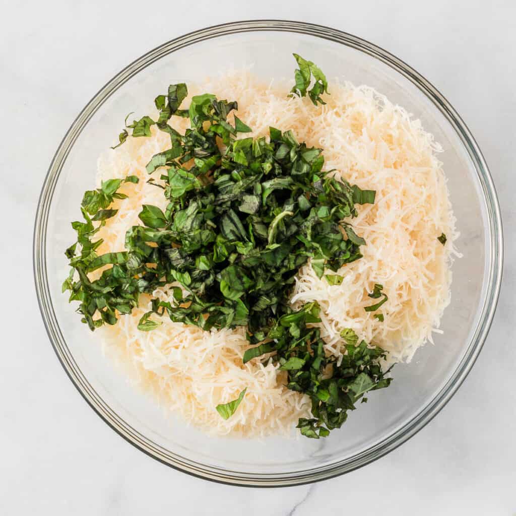 adding the fresh basil and parmesan to the ricotta
