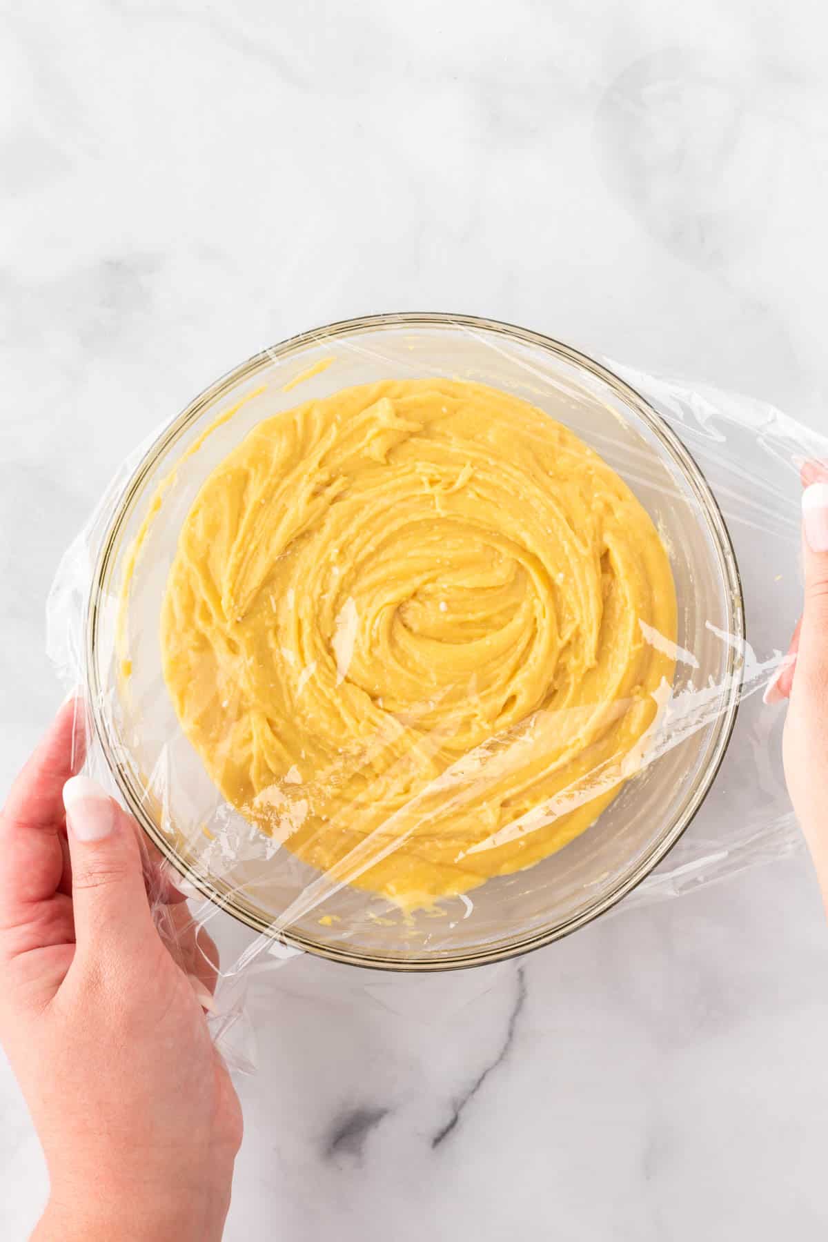 covering the cookie batter with cling wrap