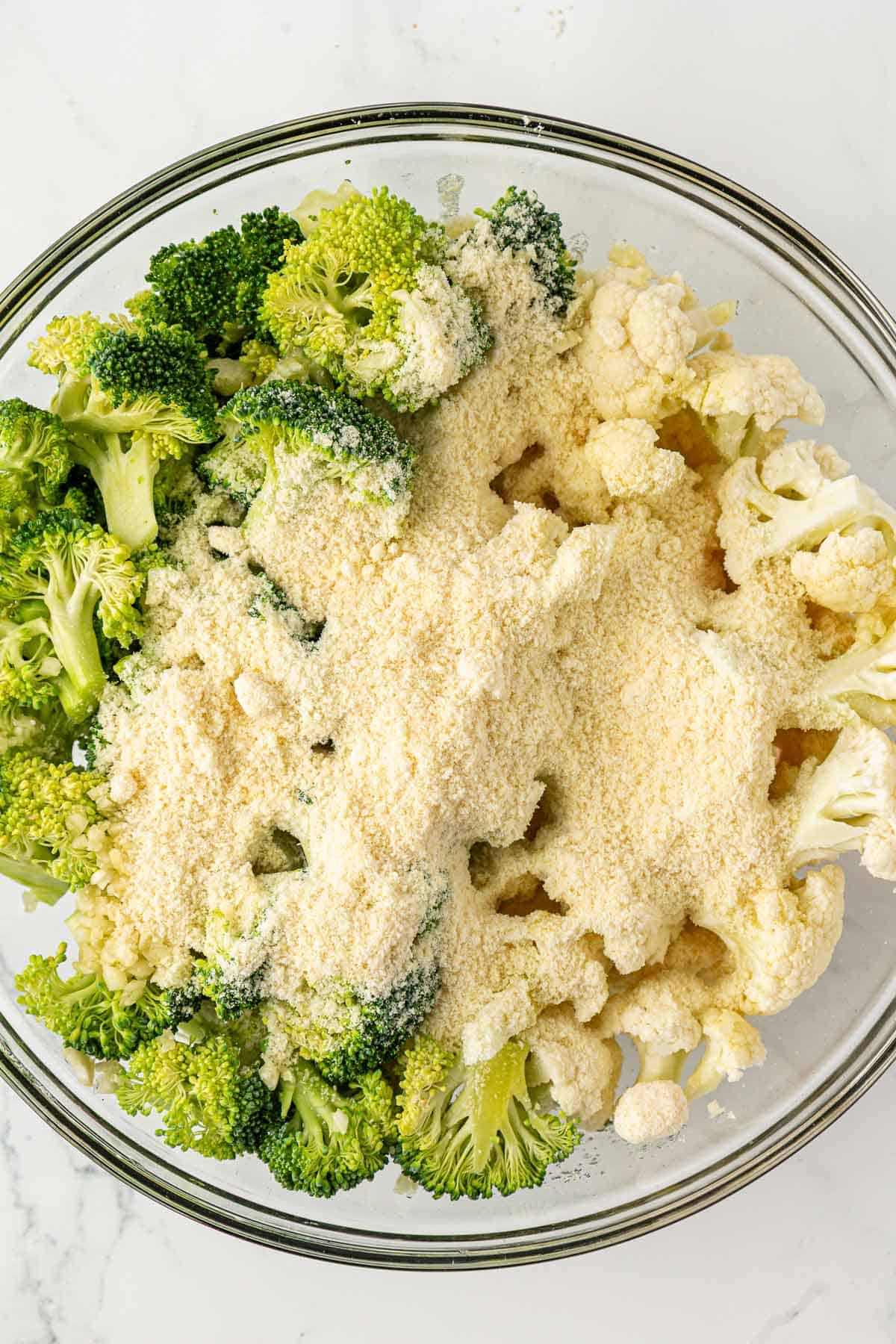 adding the parmesan cheese and garlic to the vegetables