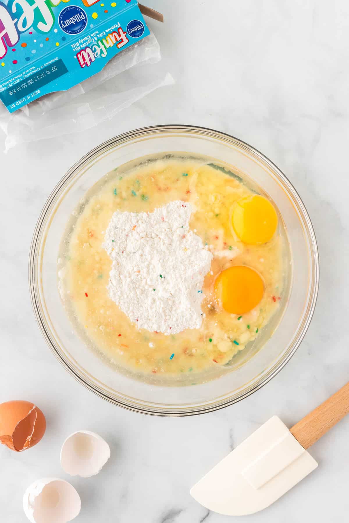 adding eggs and oil to the cake mix