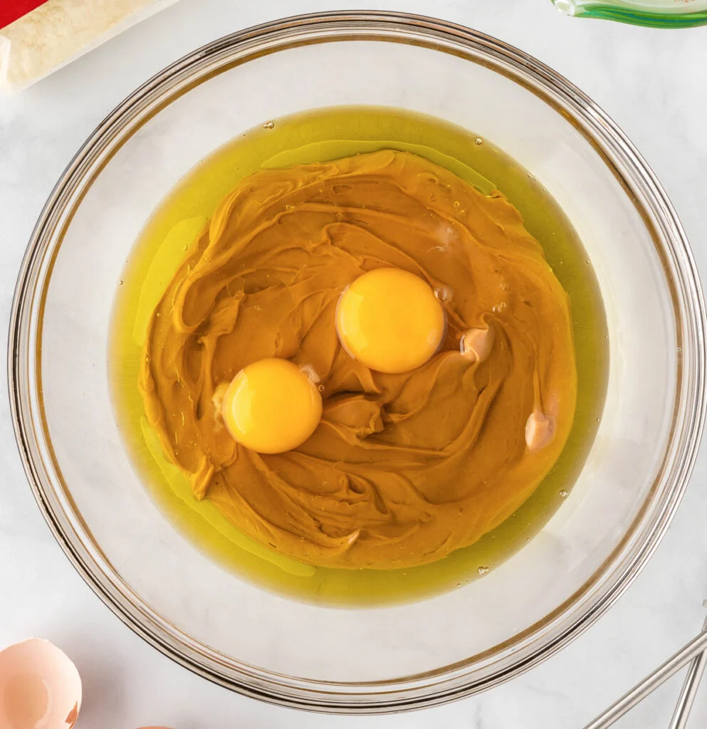 eggs, oil, and peanut butter in a mixing bowl