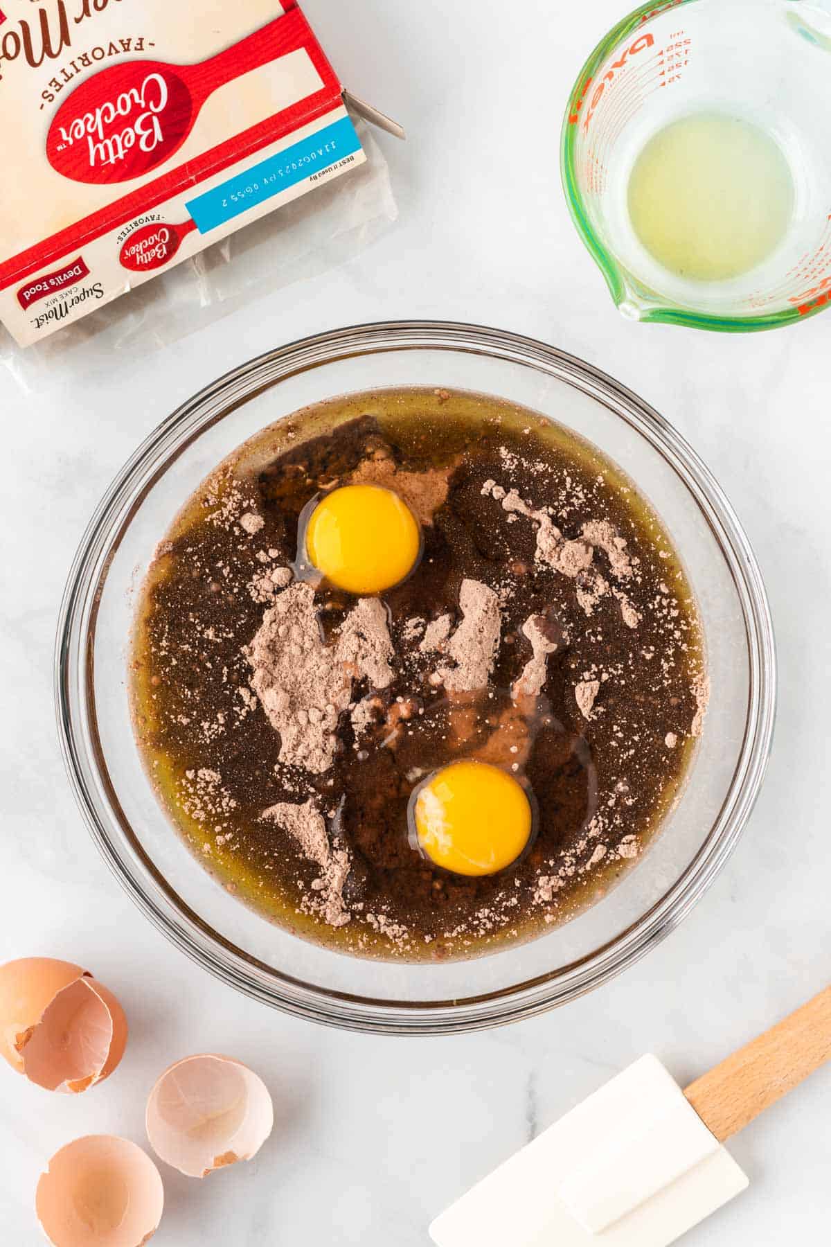 adding eggs and oil