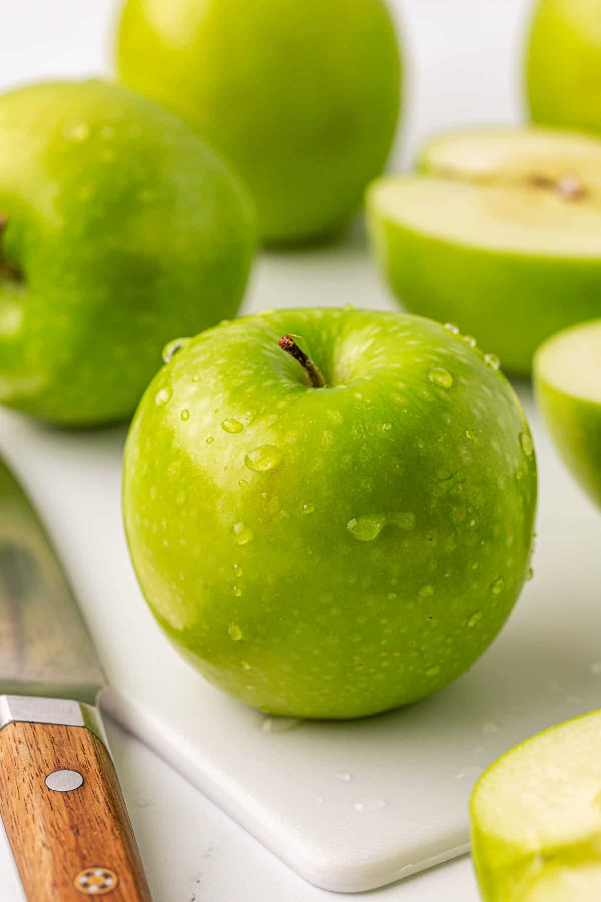 an apple on a cutting board