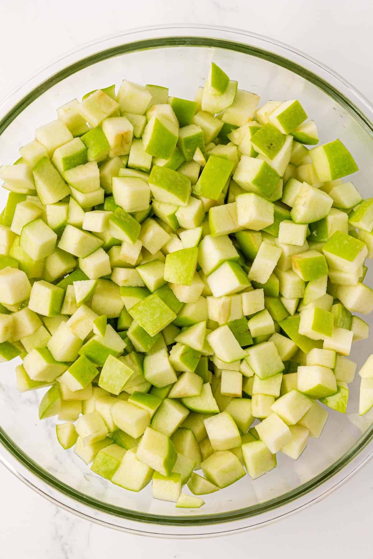 diced up apples in a mixing bowl