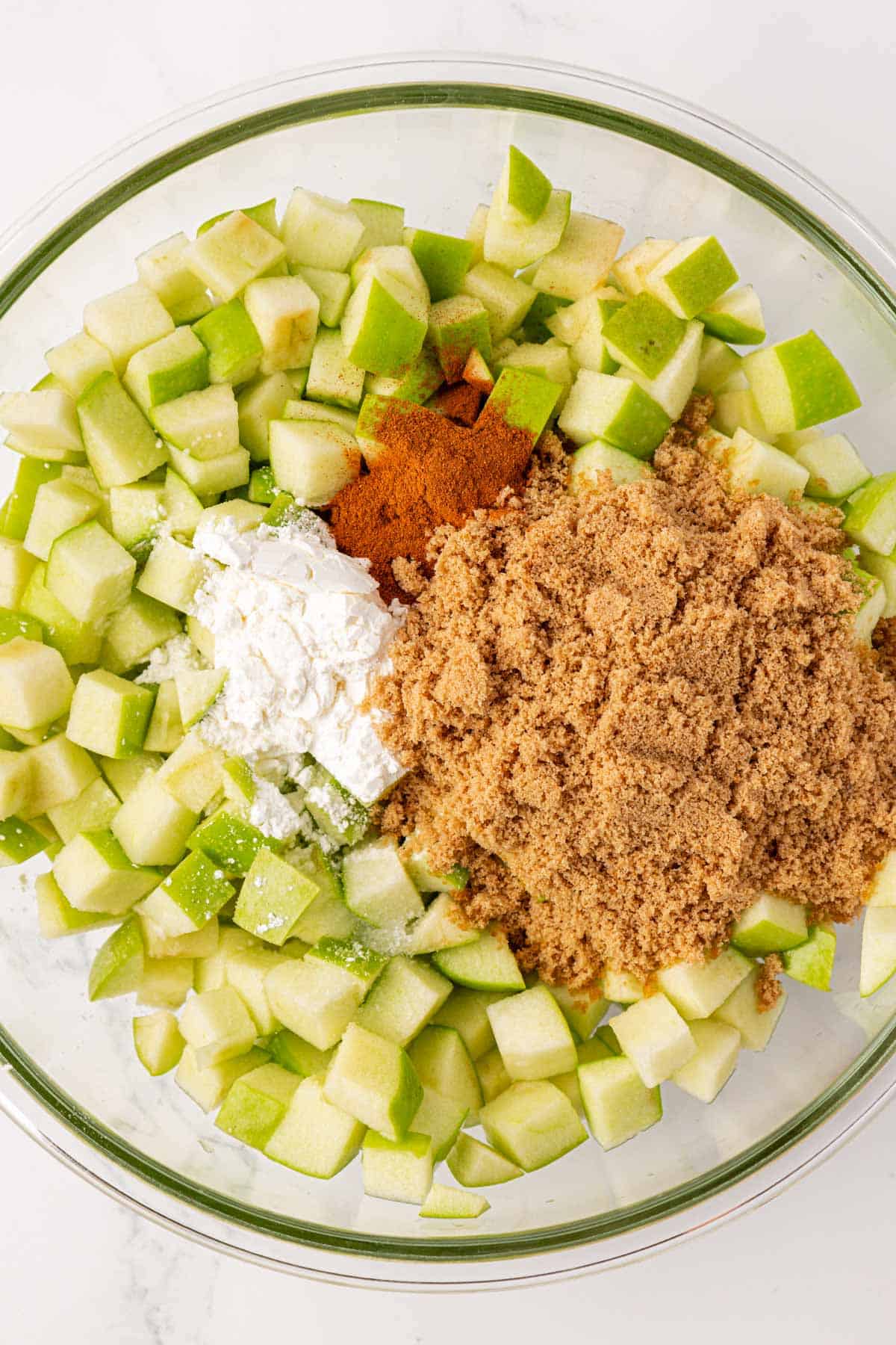 adding the spices to the apples