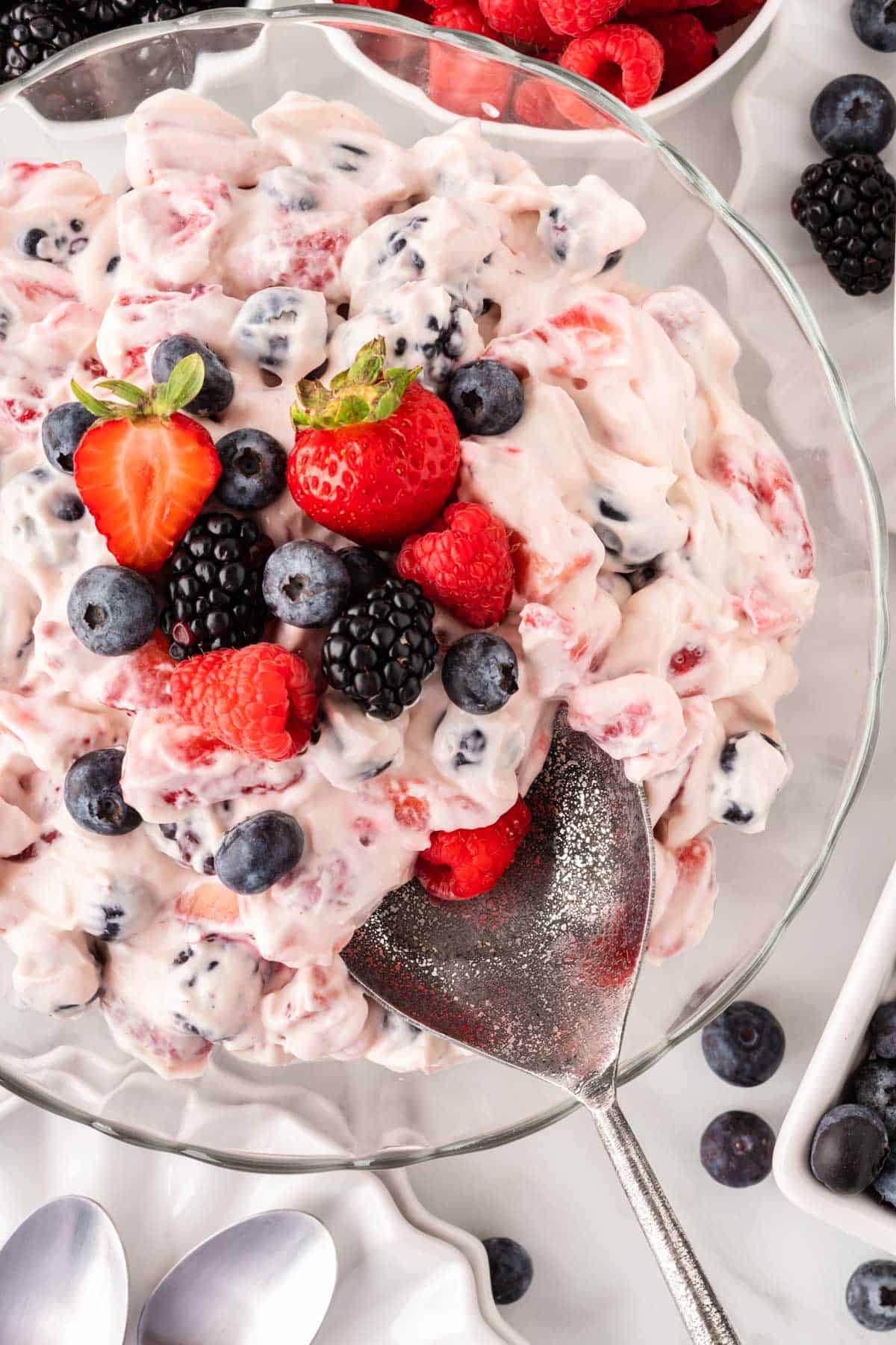 serving spoon taking a scoop of cheesecake salad
