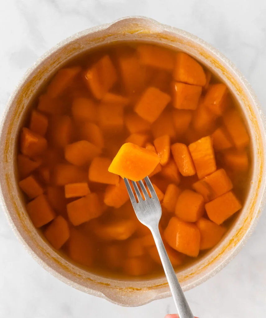 boiled sweet potato pierced with a fork