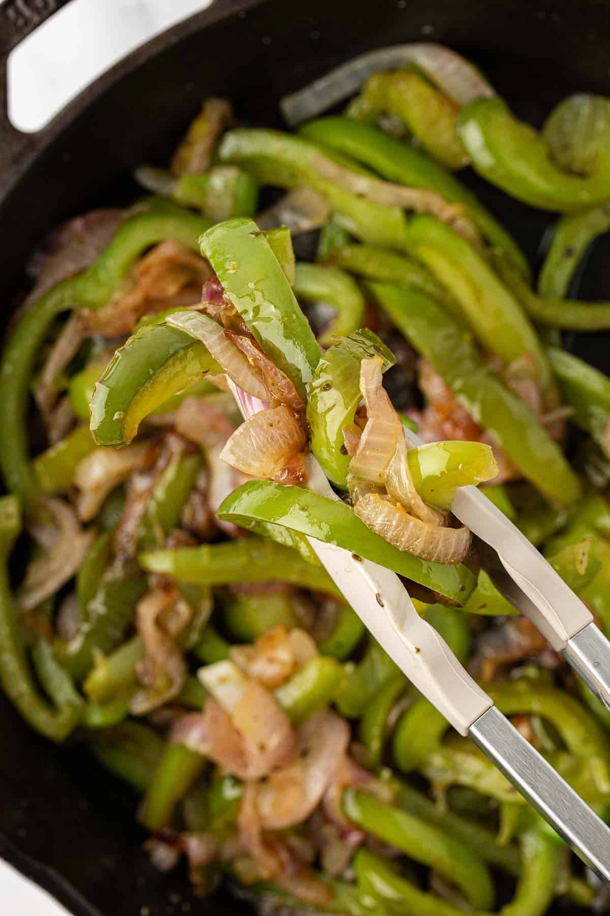 taking fajita veggies from a skillet