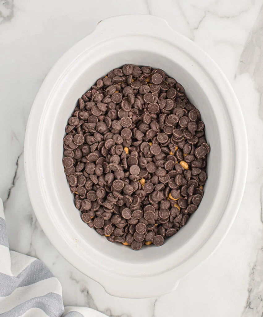 chocolate chips added to the peanuts in the slow cooker