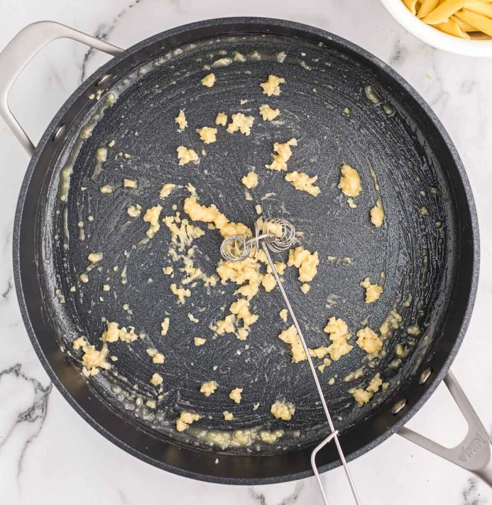 whisking flour into minced garlic and butter