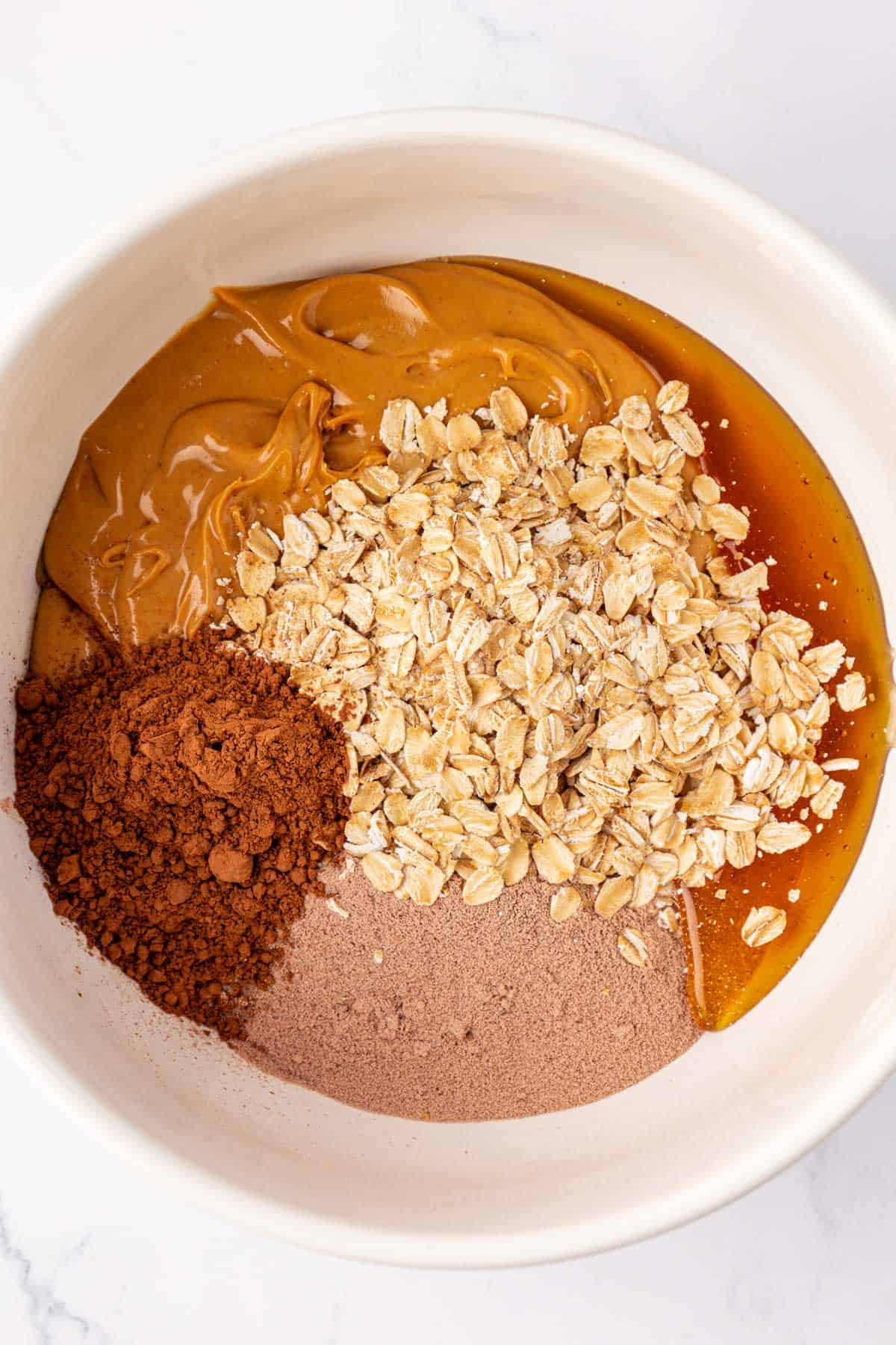 chocolate protein bar ingredients in a mixing bowl