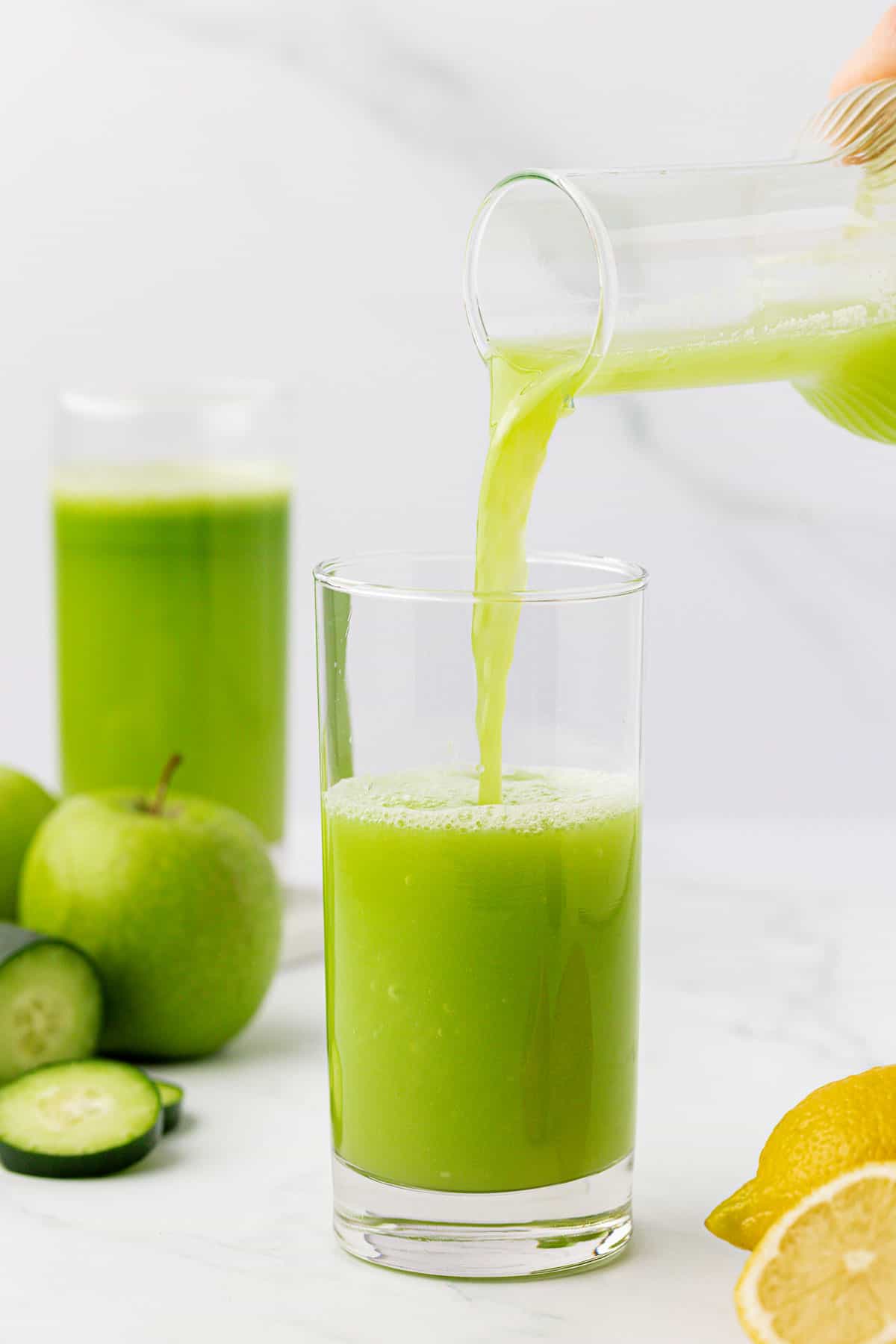 pouring cucumber juice into a glass