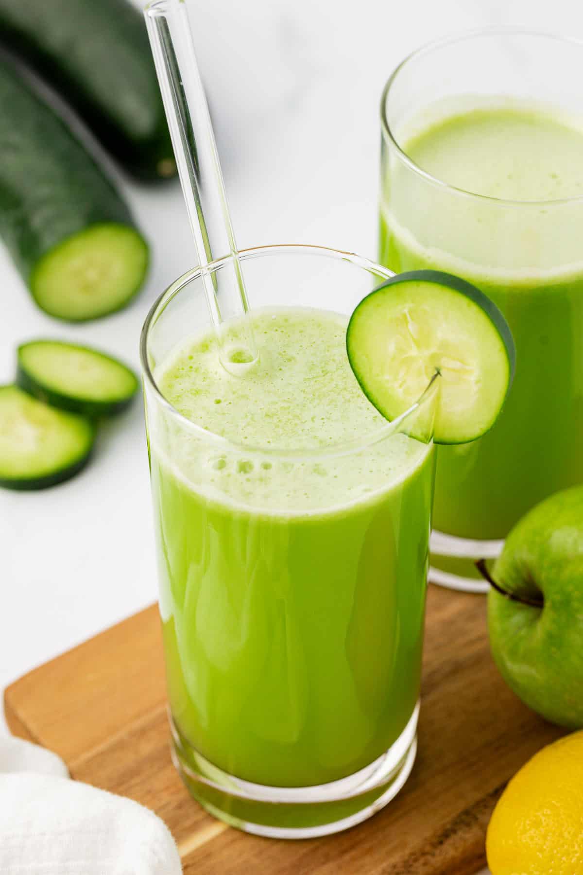 juice in a glass with a cucumber slice on the rim