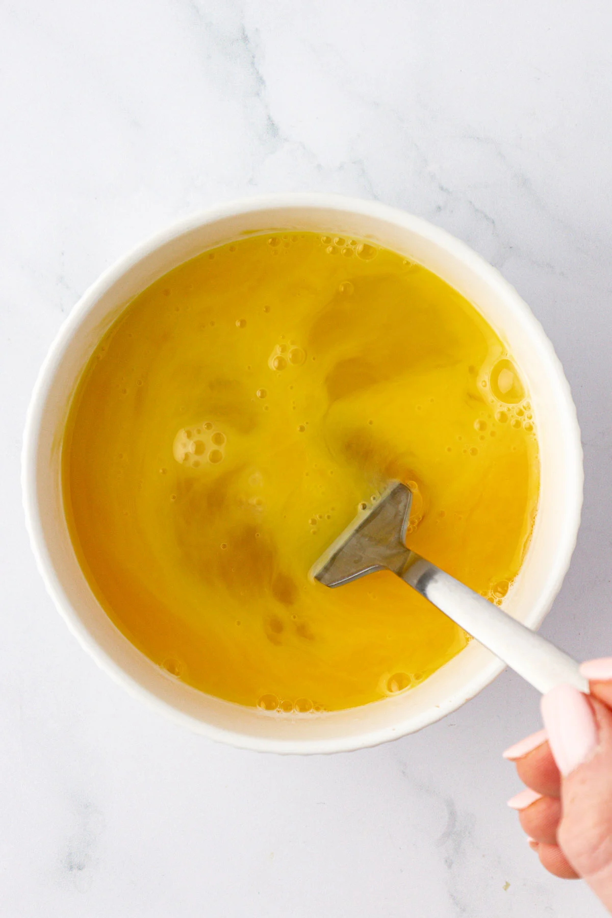 whisking eggs in a mixing bowl